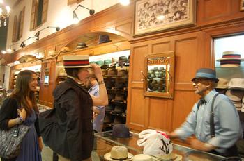 Rod Springer helps a customer try on a hat